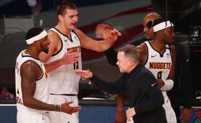 Denver Nuggets head coach Michael Malone celebrates with his team after defeating the Los Angeles Clippers in game seven of the second round of the 2020 NBA Playoffs